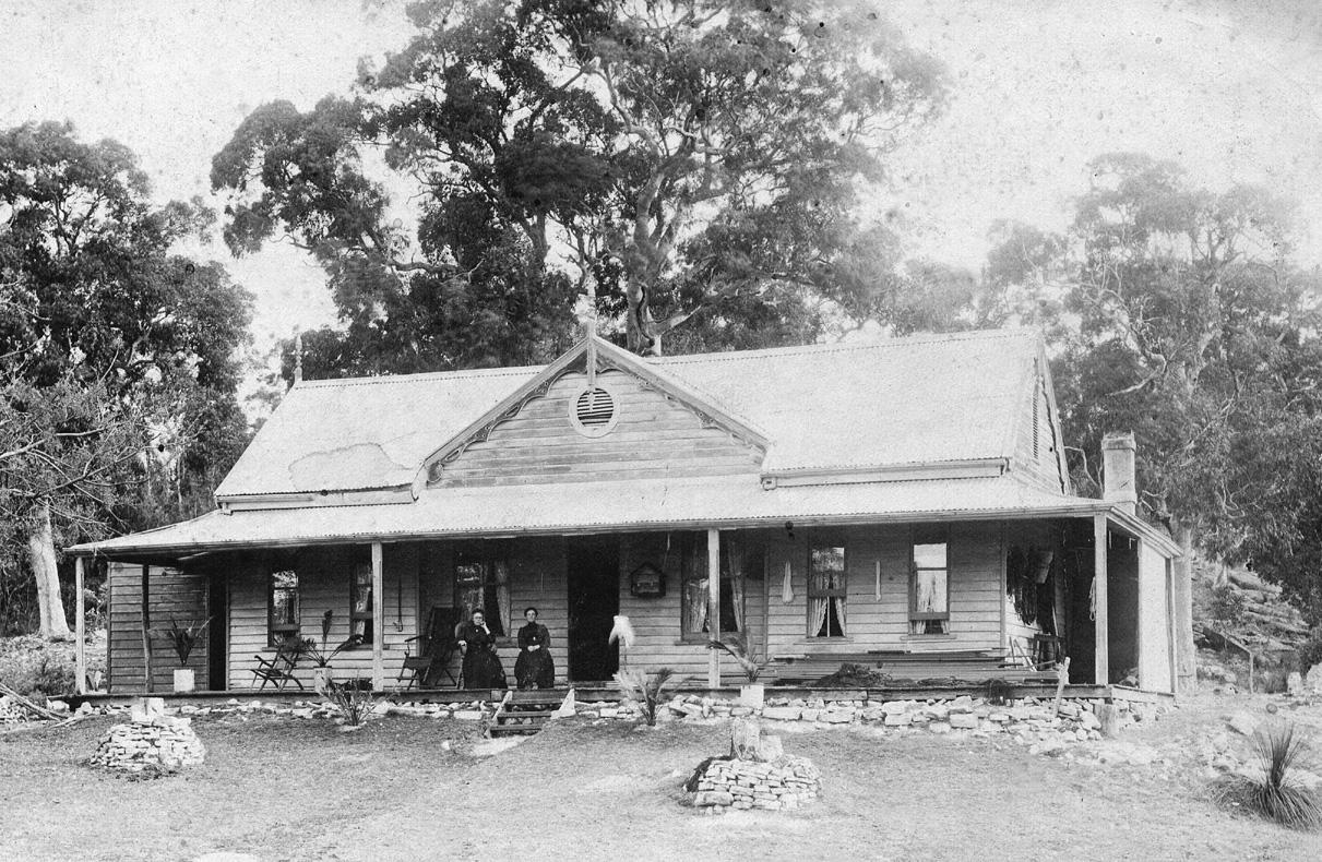 The Geddes House homestead with family on the verandah